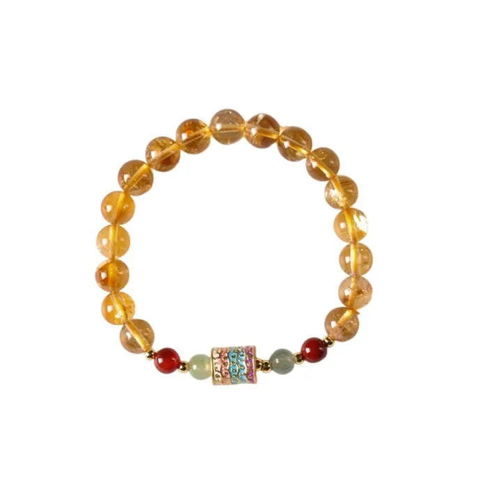Yellow citrine prayer wheel bracelet with 8mm round beads on wrist