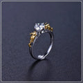 A black gold finished crown motif ring on a copper base, shown on a finger, with detailed modelling visible.