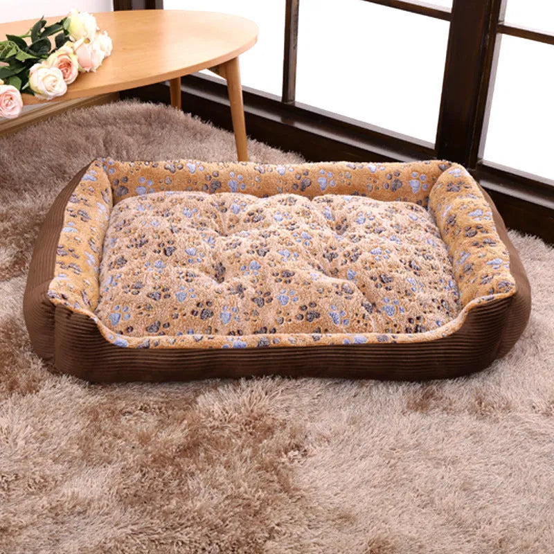 Beige sofa-style plush pet bed for small dogs with raised basket edges on a wooden floor.