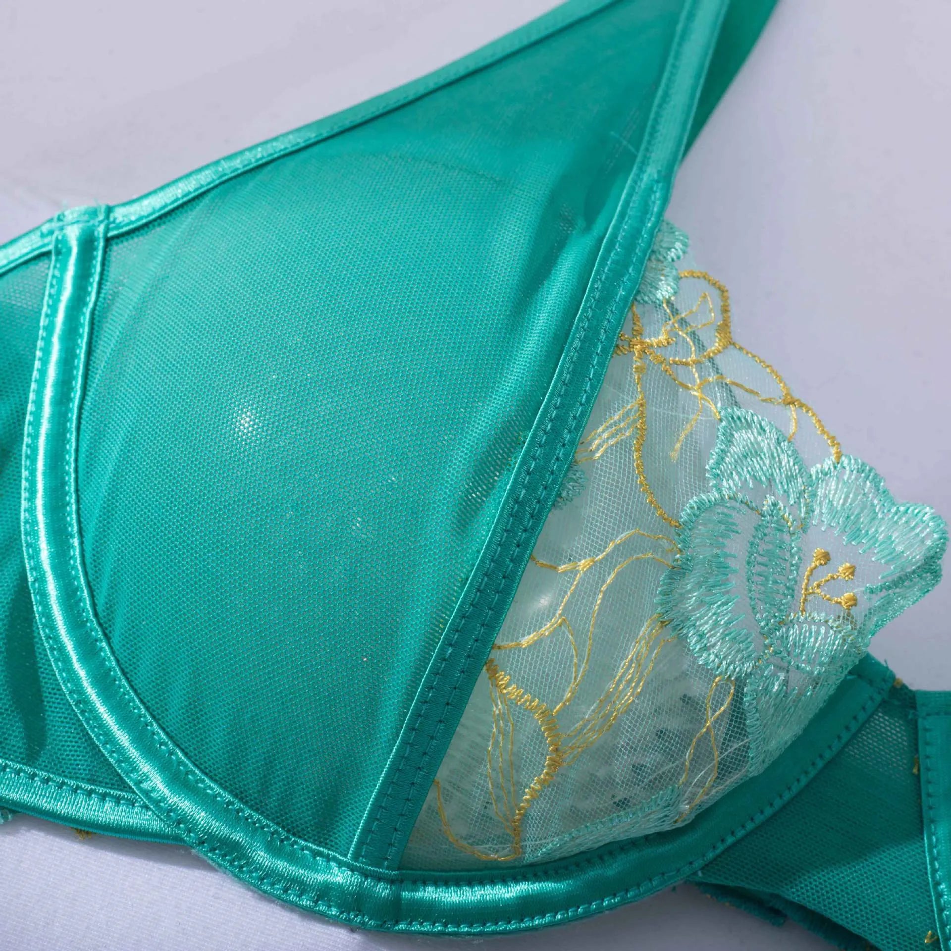 Light green women's bra set with embroidery detail and matching bikini bottoms