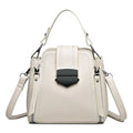 Small square vertical ladies handbag in soft textured PU leather, showing sewing thread detail.