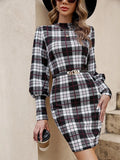 Black tight dress with lantern sleeves and leather stitching detail.