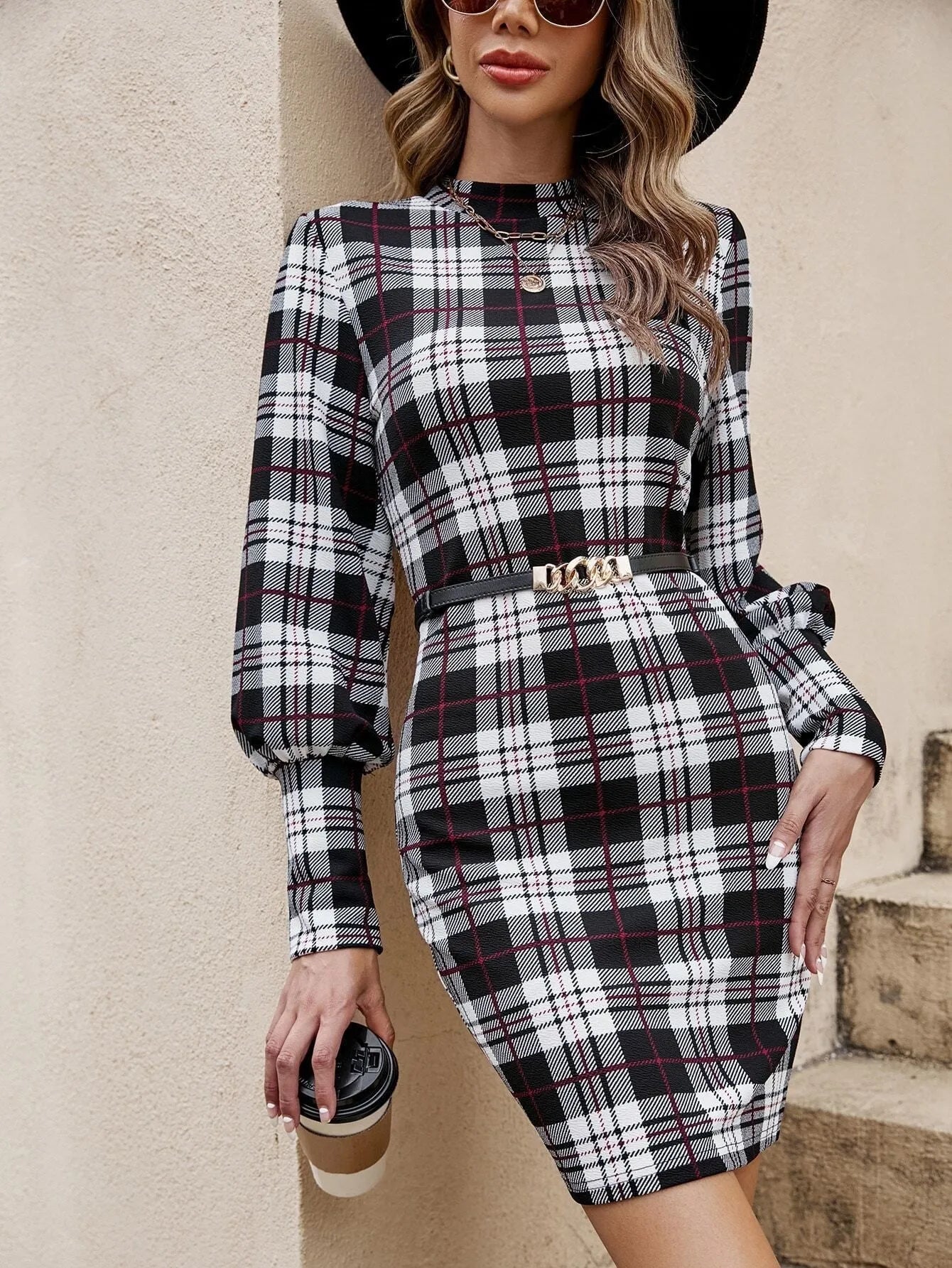 Black tight dress with lantern sleeves and leather stitching detail.