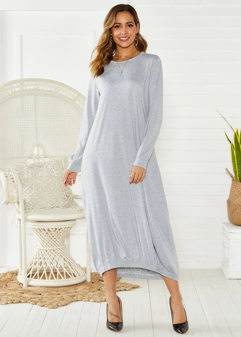 Black loose lantern dress with lace-up crew neck detail on a hanger.