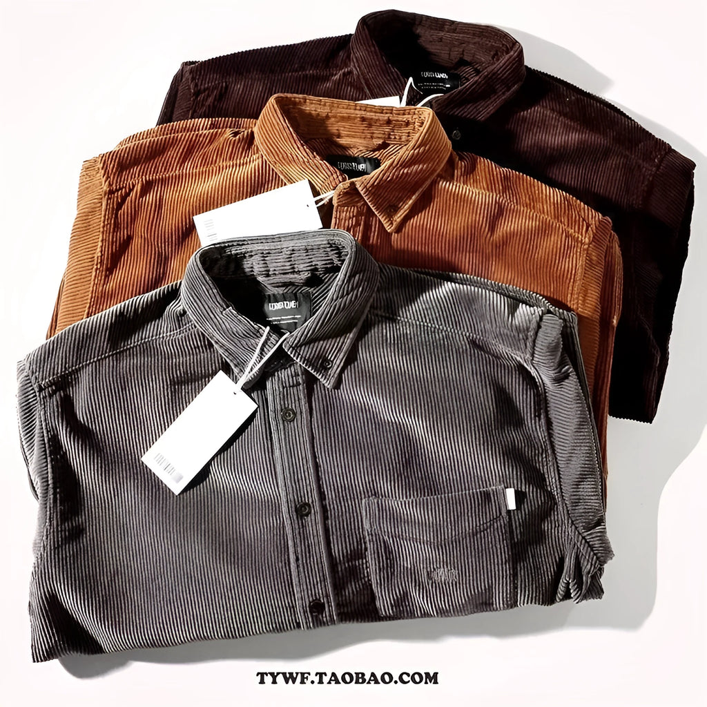Caramel coloured loose fit corduroy cardigan shirt with long sleeves on a hanger.