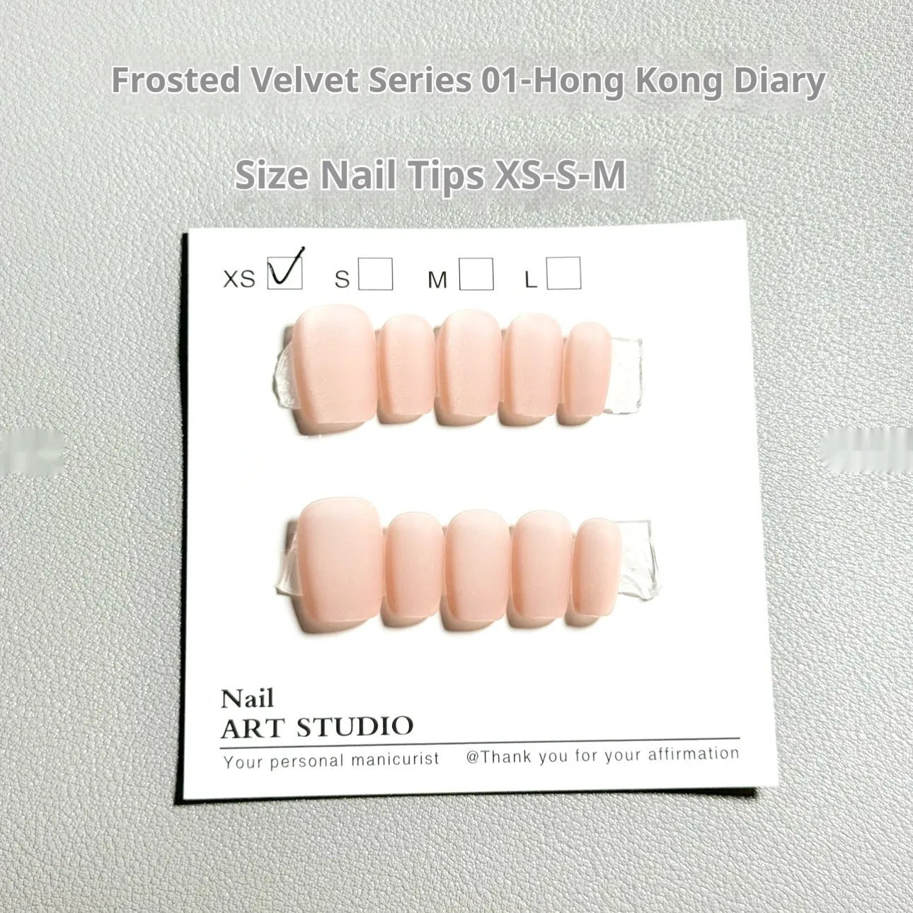 Set of frosted velvet cat's eye false nails with aurora armour design in short ladder sizes on a clear background.