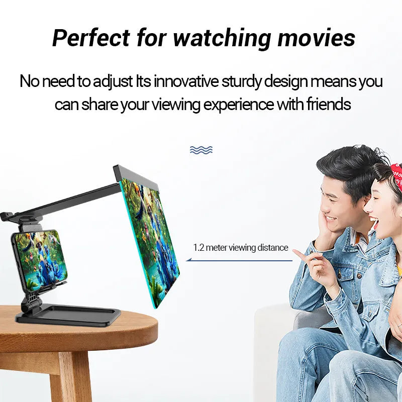 Black foldable mobile phone screen amplifier and detachable holder set up on a desk.