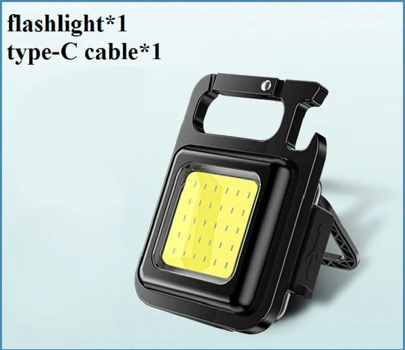 Mini portable COB keychain flashlight with USB recharge, 400 lumens, and built-in bottle opener