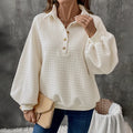 Women's milky white thick knit sweater with a polo collar.