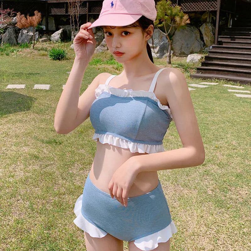 Solid colour conservative one-piece swimsuit for women with suspender straps.