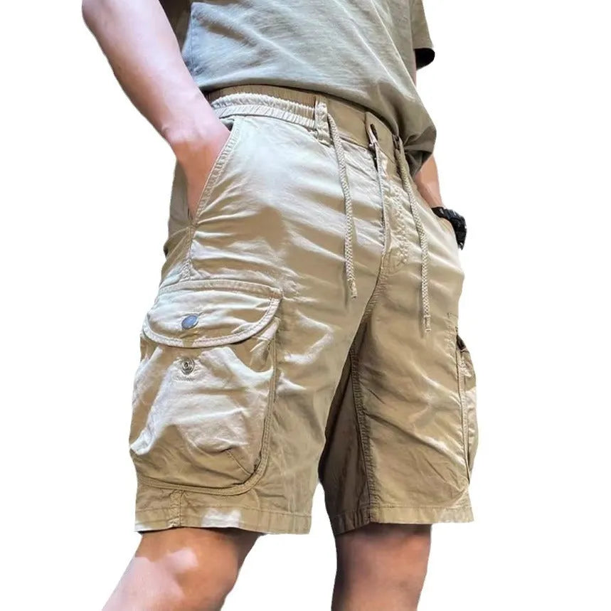 Loose straight-leg Korean-style casual overalls in khaki with multiple pockets on a neutral background.