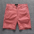 Men's cotton shorts in camouflage green with a zip fly and mid-rise waistband.