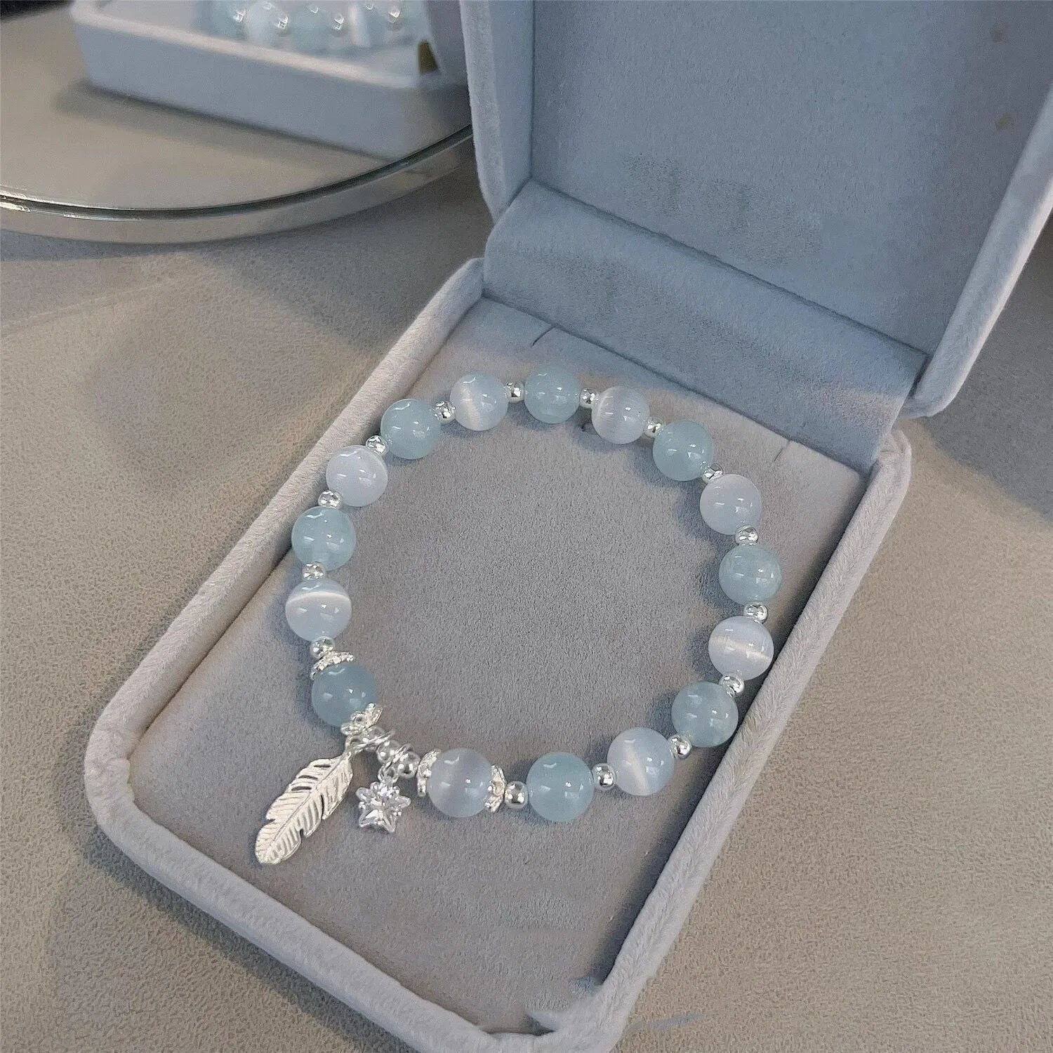 Small white crystal bracelet with blue moonlight colour and star design, Korean-style glass jewellery.