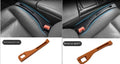 Black plastic car seat gap storage box with handle between vehicle seats