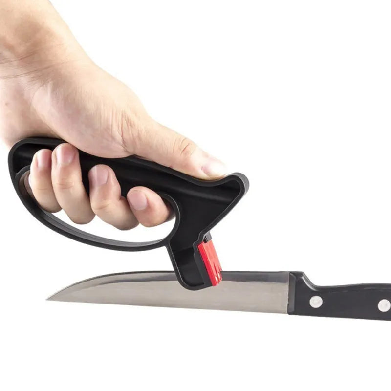 Black handheld knife and scissor sharpener with ergonomic handle on a plain background.