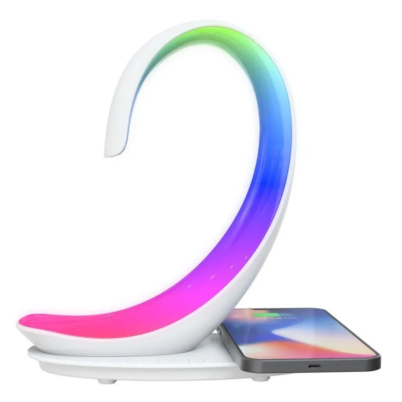 White swan-shaped desktop gadget with wireless charging pad, Bluetooth speaker, and colourful LED atmosphere light.