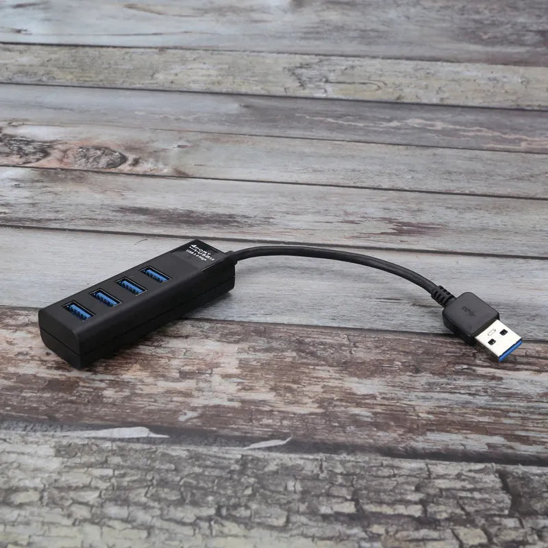 Black USB 3.0 hub with four ports, LED indicators, and a 30cm connecting cable.