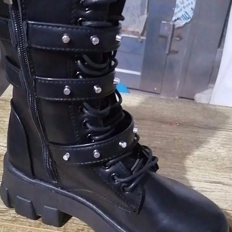A pair of black women's mid-calf boots with a side zip and a round toe, showing the metal buckle detail.