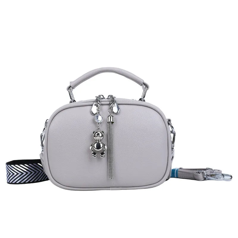 Women's small square bag with stitching detail showing oval shape and double shoulder straps