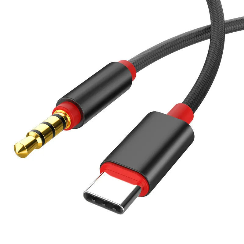Black and silver nylon-braided 3.5mm audio auxiliary cable on a white background.