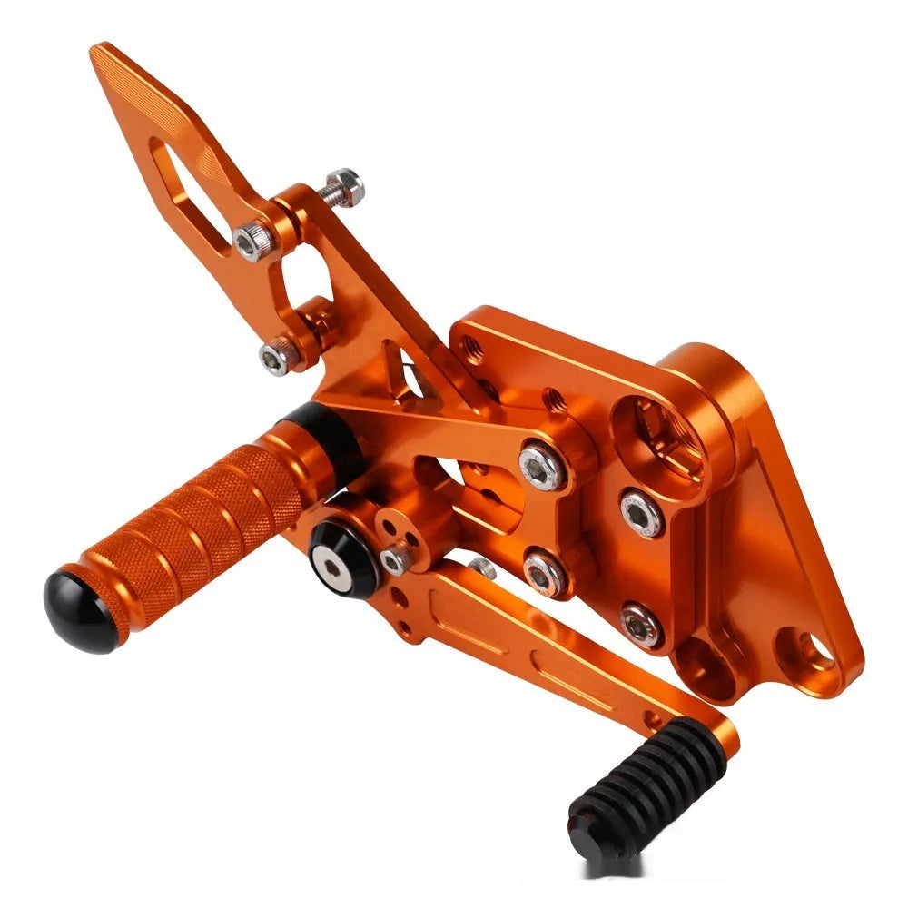 Black and orange KTM Duke motorcycle rear shift pedal support bracket assembly.