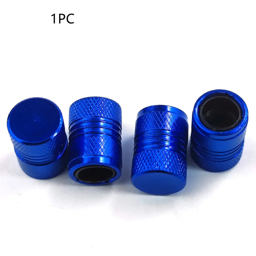 Aluminium car tyre valve dust cap in four colour options: black, blue, grey, and red.