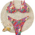Red floral patterned women's underwire triangle bikini top and briefs on a mannequin.
