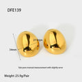 Geometric gold-coloured ear studs with glazed surface and line design details