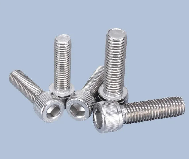 Stainless steel phono cartridge mounting kit with allen bolts, nuts, washers, and two allen keys on a grey background.