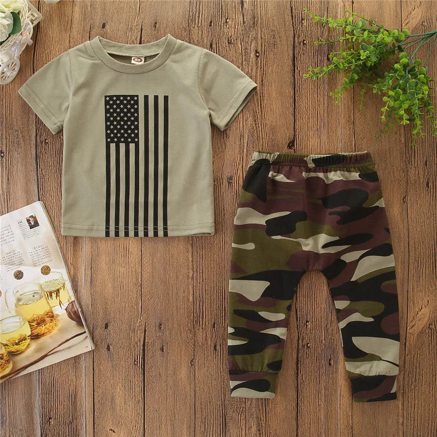 Little boy wearing a camouflage pattern short-sleeved shirt and trousers summer suit set.