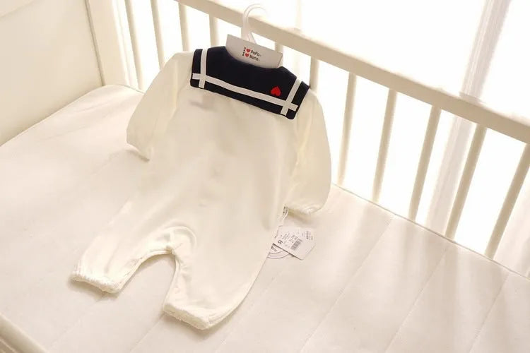 Navy style long-sleeved baby onesie with detachable hood and single-breasted snap closure.