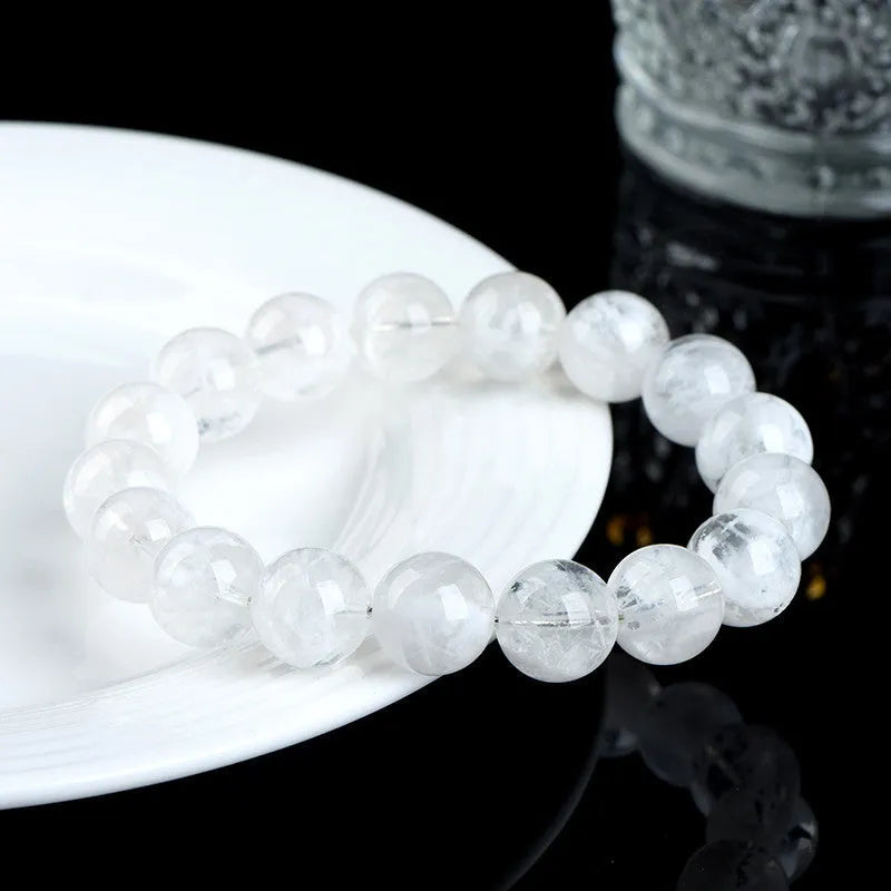Women's crystal bracelet with round blizzard snowflake beads and traditional Ruyi and Xiangyun symbols.