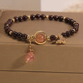 Black butterfly pendant bracelet with stone construction and red rock elements
