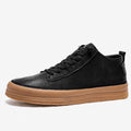 Men's black leather casual trainers with white rubber soles and laces on a white background.