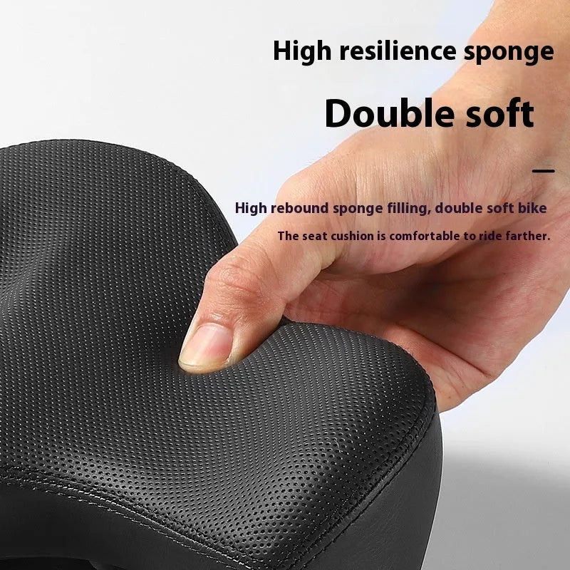 Black leather bicycle seat cushion with thick foam padding for shock absorption.