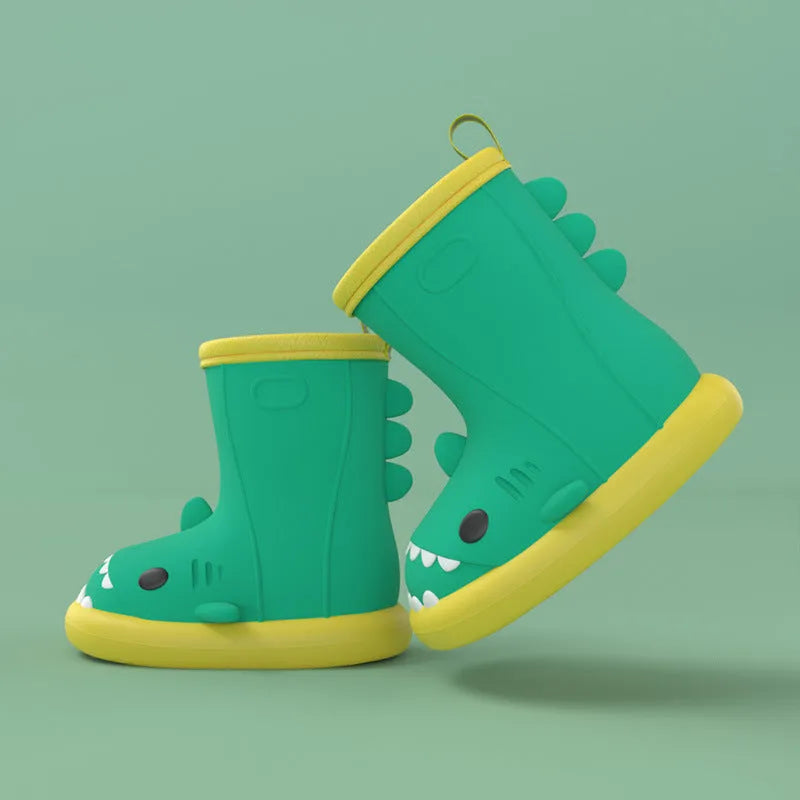 Shark brand children's green rain boots with a dinosaur graphic, showing medium height and plastic construction.