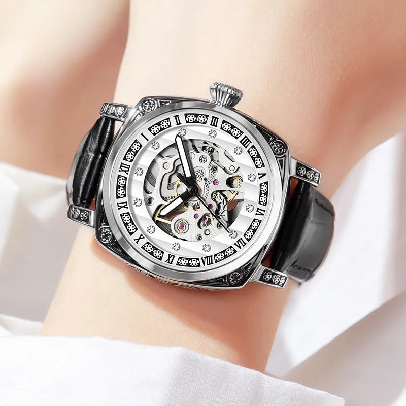 Mechanical watch with luminous hands and a leather strap on a wrist, showing black case variant.