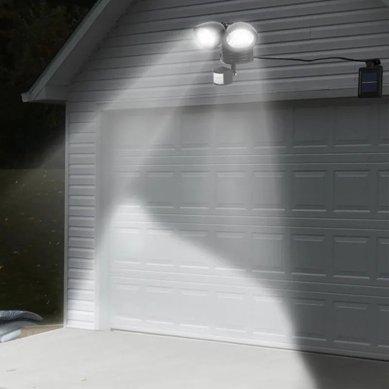 Black and white dual head solar security spotlight with motion sensor for outdoor wall mounting
