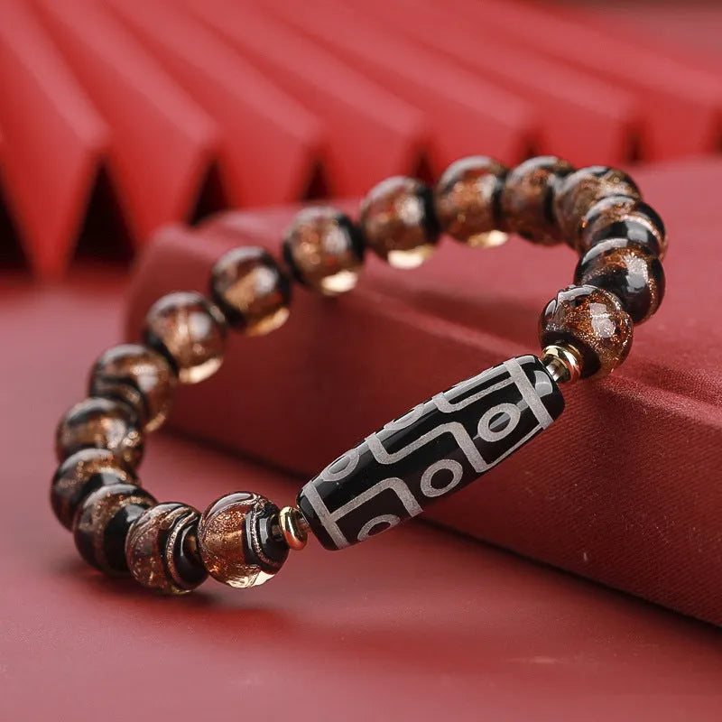 Close-up of a handmade Chinese-style bracelet with coloured glaze lucky beads on a snake theme.