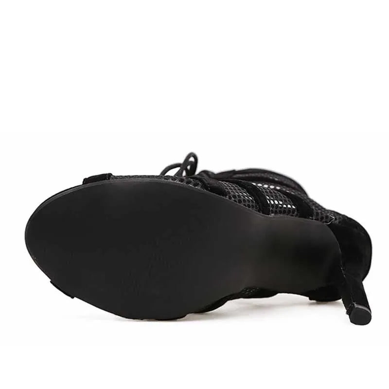 Black suede women's lace-up high heel shoes with an ankle strap, shown from the side on a white background.