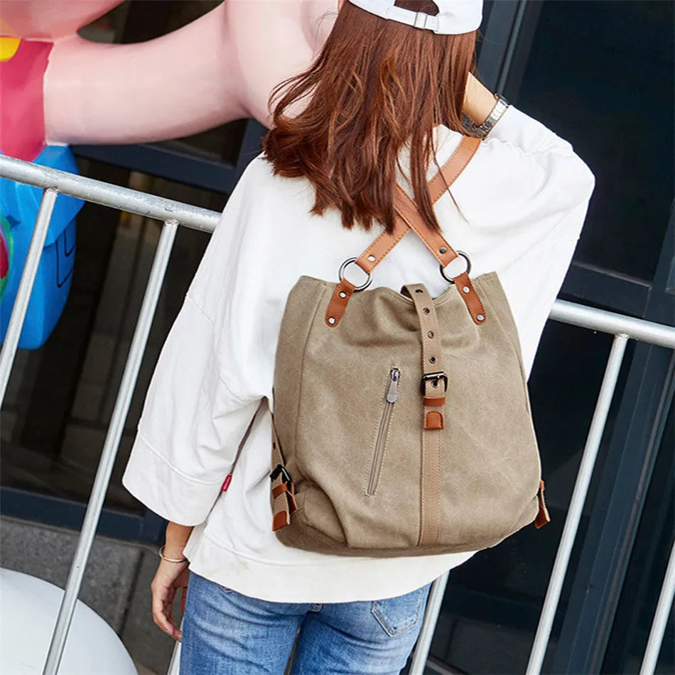 Soft canvas handbag with anti-theft device, curved shoulder strap, and digging bag outer pocket in black