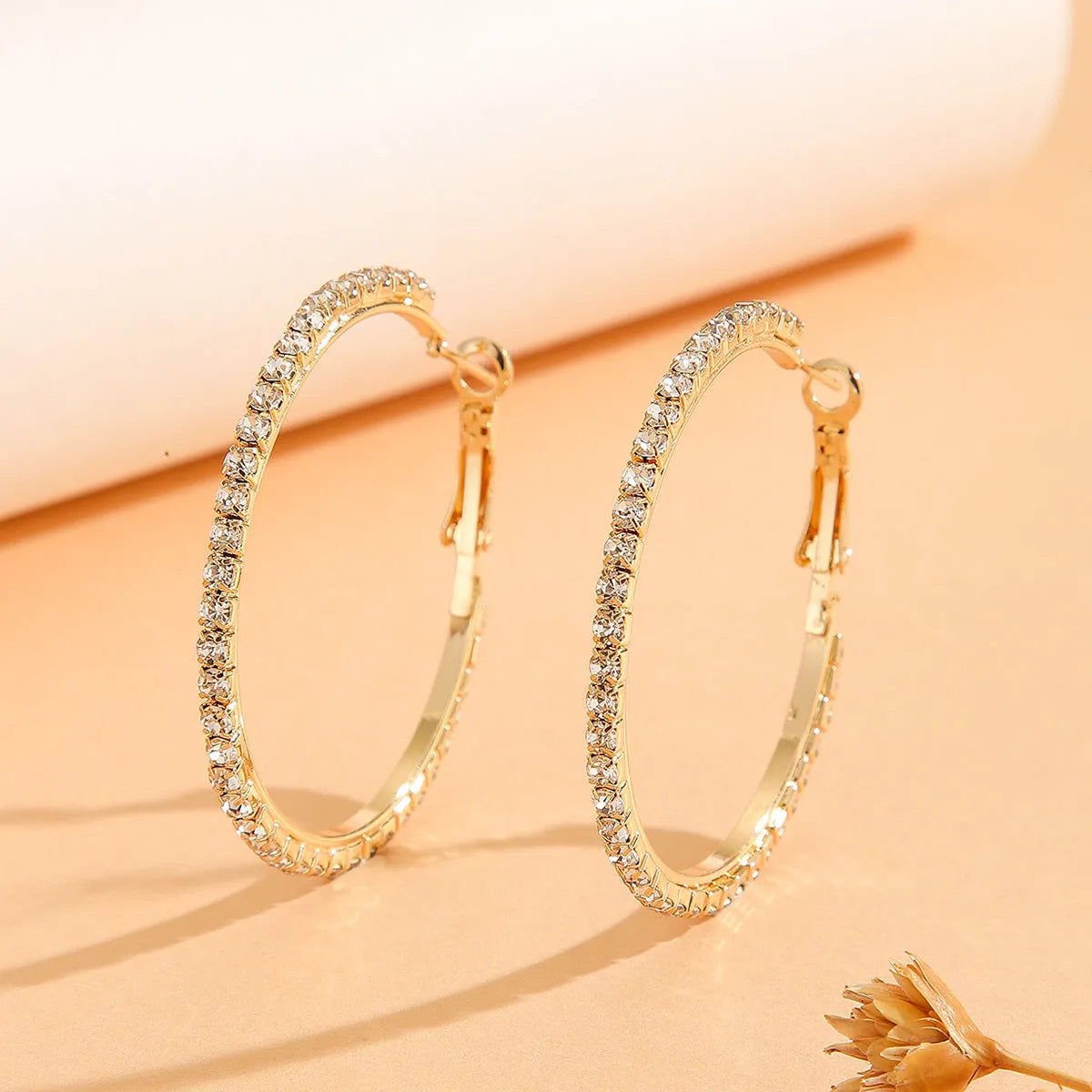 Large gold plated copper zircon hoop earrings for women, princess style, gold colour, on white background