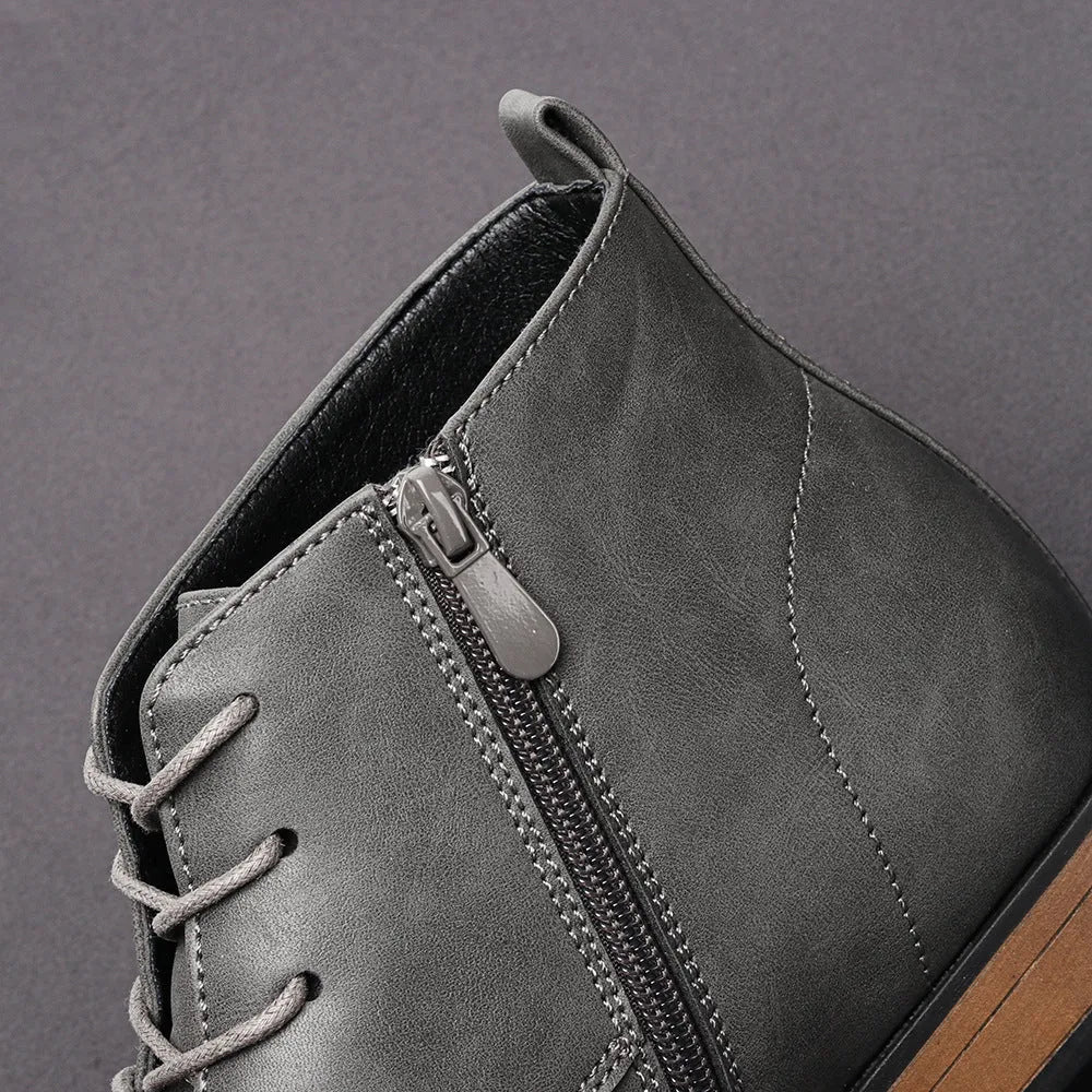 Men's brown Chelsea boot with a side zip, round toe, and low wooden heel on a white background.