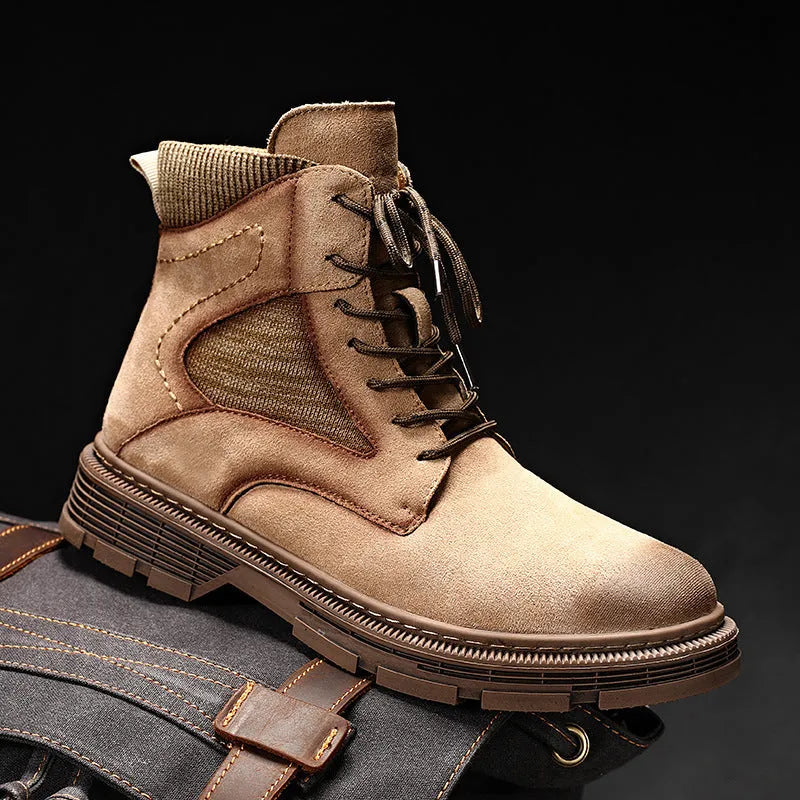 Men's ankle-high Martin boots in frosted grey leather with a thick rubber sole and round toe on a wooden floor.