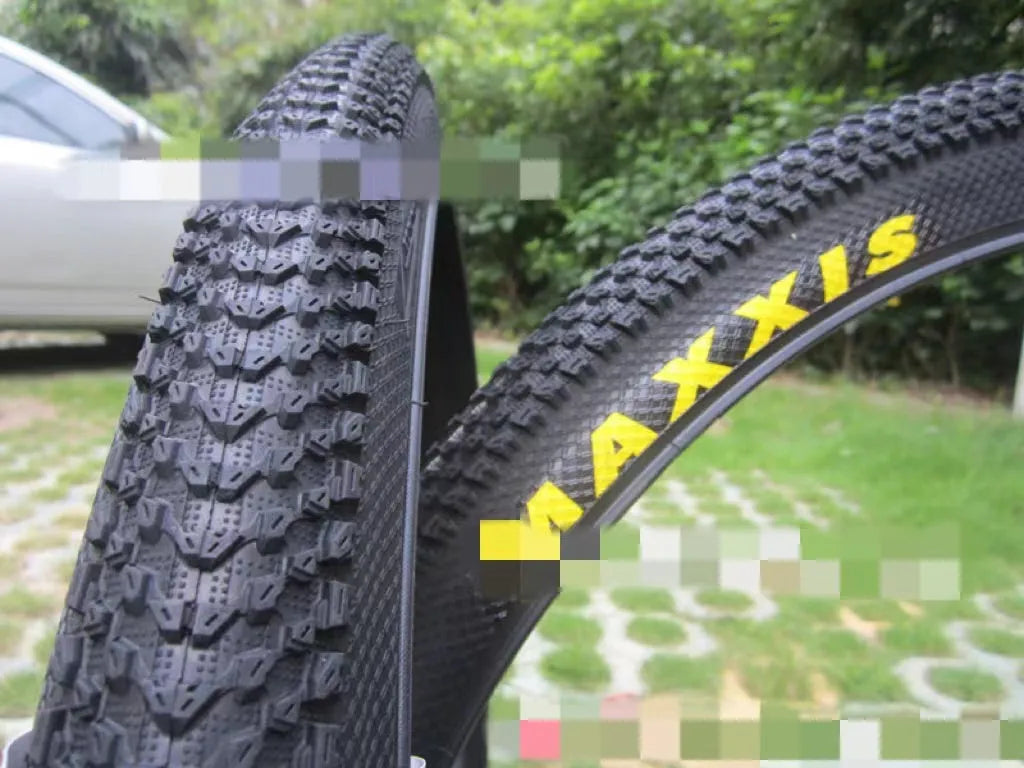 Ultralight mountain bike tyre with black tread and optional white sidewall, shown in sizes 26, 27.5 and 29 inch.