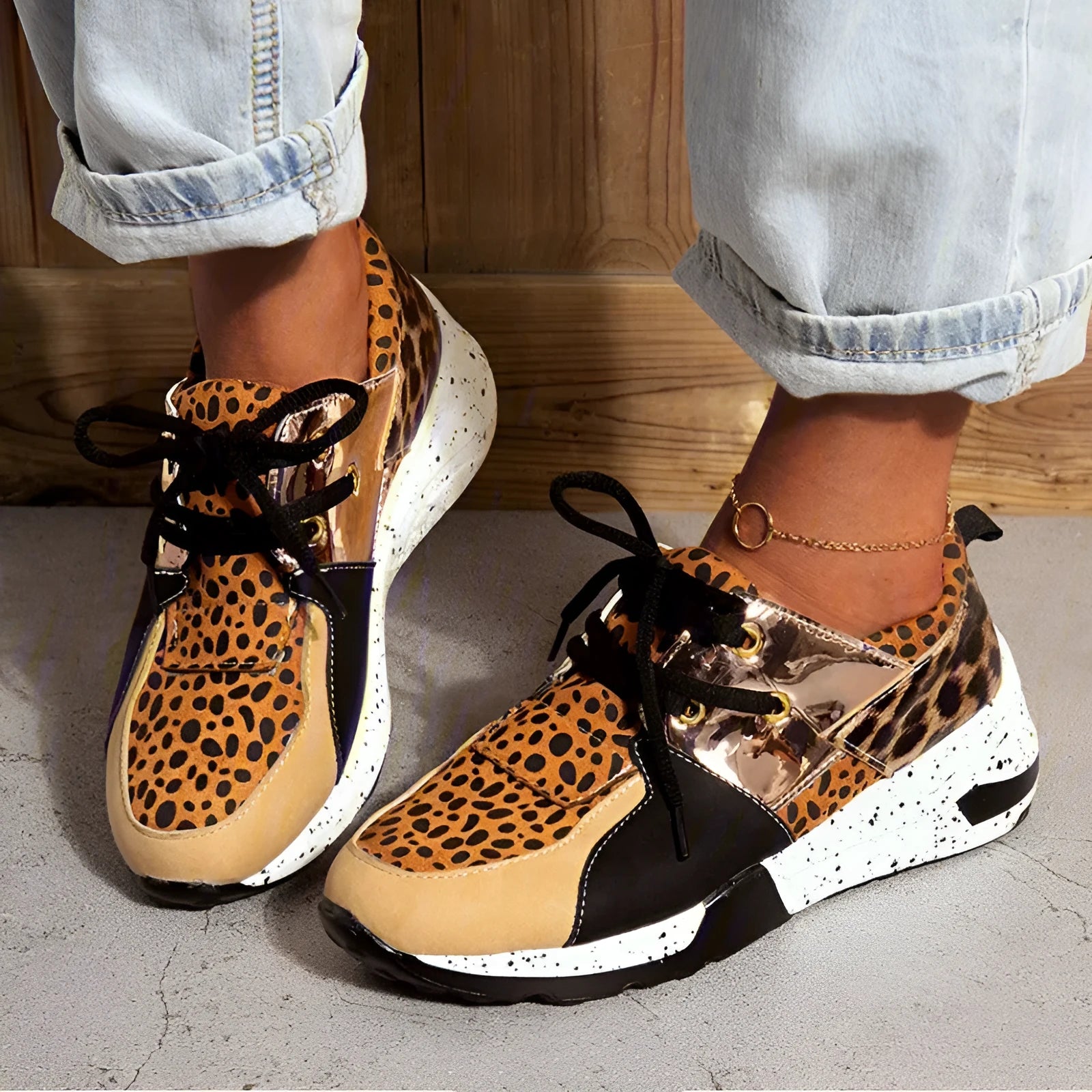Women's black suede casual sneakers with a low wedge heel and round toe on a white background.