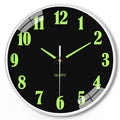 Modern 8 inch luminous wall clock in plastic case on a wall.