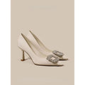 Women's creamy-white pointed toe stiletto high heels with a mid-height heel on a plain background.