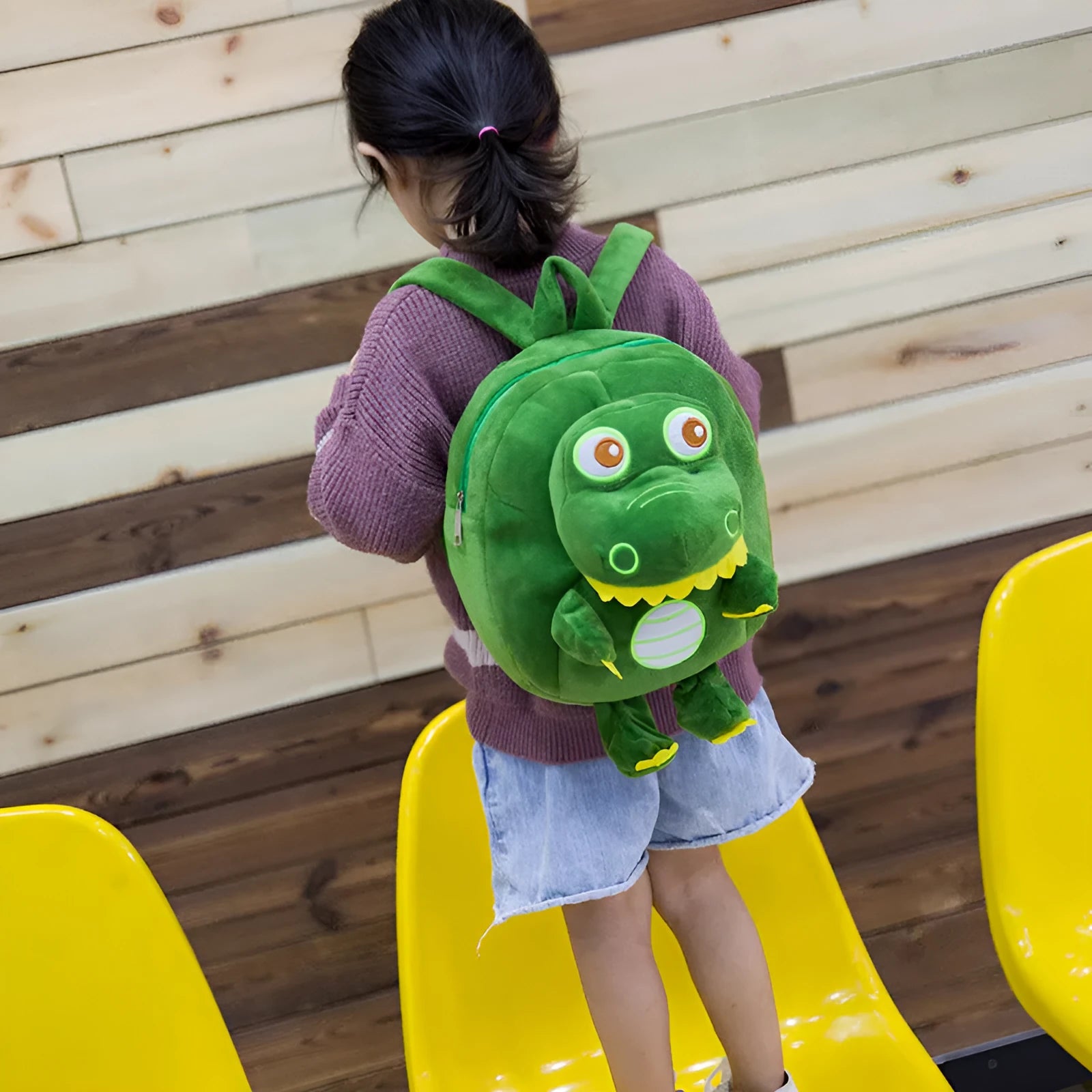 Baby dinosaur plush toy backpack with embroidery design in blue colour showing soft handle and animal pattern