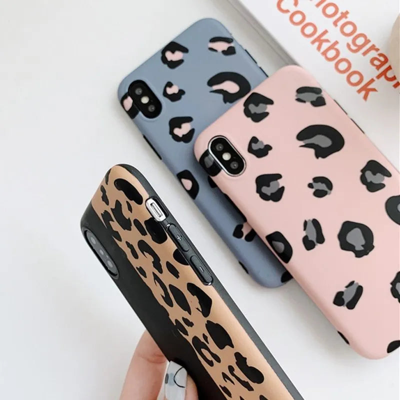 Leopard print protective mobile phone case for iPhone in black, blue, and pink colour options.
